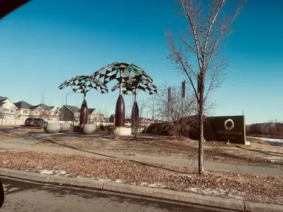 a sculpture of a tree on the side of a street at Brand New 3 Bedroom house SW Edmonton in Edmonton