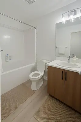 a bathroom with a toilet and a sink and a mirror at Condo w 2 Beds 13 Mins from West Edmonton Mall in Edmonton