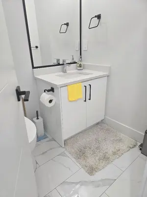 a white bathroom with a sink and a mirror at Cy Becker Drive 2023 Luxury Home in Edmonton