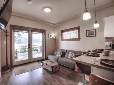 a living room with a couch and a table at Going Coastal ABC - Oceanfront - Pet Friendly in Port Renfrew