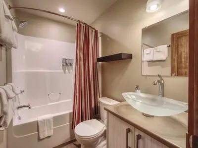a bathroom with a sink and a toilet and a shower at Going Coastal ABC - Oceanfront - Pet Friendly in Port Renfrew