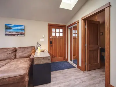 a living room with a couch and a table at Going Coastal ABC - Oceanfront - Pet Friendly in Port Renfrew