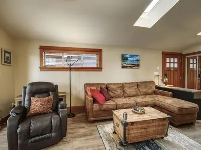 a living room with a couch and a chair at Going Coastal AB - Oceanfront - Pet Friendly in Port Renfrew