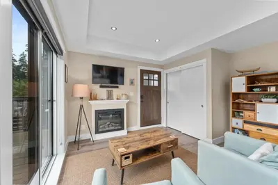 a living room with a couch and a table at Spacious Oceanview - 2 living rooms & fridges - Pet Friendly in Port Renfrew