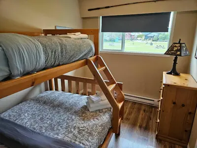 a bedroom with a bunk bed and a window at The Outfitter - Garden View - Pet Friendly - Huge yard in Port Renfrew