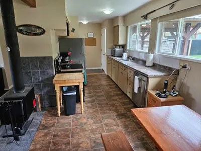 a kitchen with a stove and a counter in it at The Outfitter - Garden View - Pet Friendly - Huge yard in Port Renfrew