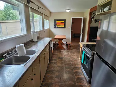 a kitchen with a sink and a counter top at The Outfitter - Garden View - Pet Friendly - Huge yard in Port Renfrew