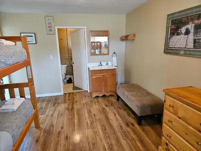 a bedroom with a sink and a bunk bed at The Outfitter - Garden View - Pet Friendly - Huge yard in Port Renfrew
