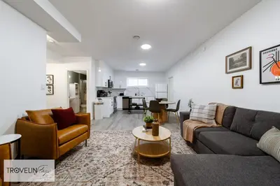 a living room with two couches and a table at Spacious Private Apartment with King Bed, Full Kitchen and In-Suite Laundry in Edmonton