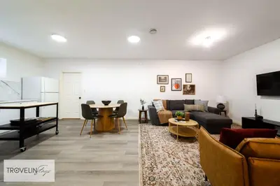 a living room with a couch and a table at Spacious Private Apartment with King Bed, Full Kitchen and In-Suite Laundry in Edmonton