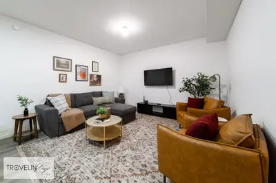 a living room with couches and a flat screen tv at Spacious Private Apartment with King Bed, Full Kitchen and In-Suite Laundry in Edmonton
