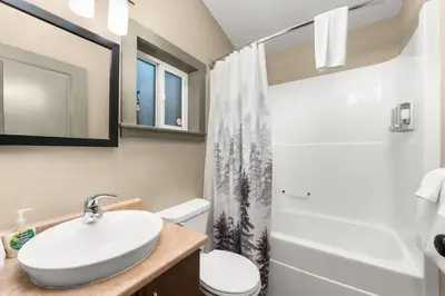 a bathroom with a sink and a toilet and a shower at JDF Waystation Cabin - Garden View - Pet Friendly in Port Renfrew
