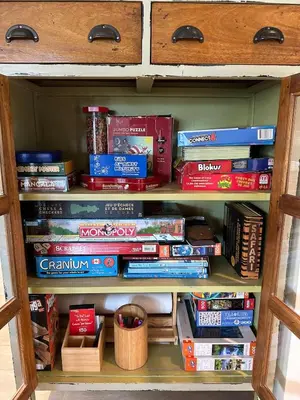a book shelf filled with lots of books at The Point Partial - Hot tub - Sauna - view of San Juan Bay - Pet Friendly in Port Renfrew