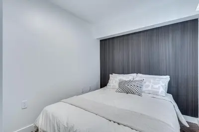 a bedroom with a large bed with white sheets and pillows at Prime West End 2BR- Central Vancouver Lifestyle in Vancouver