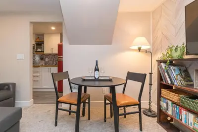 a dining room with a table and two chairs at 2 Bedroom 1 Bath On An Oak Tree Lined End Street On The Galloping Goose in Victoria