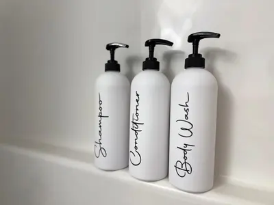 a group of three white bottles sitting on a shelf at Family Friendly GarageFireplace Sleeps 8 in Edmonton
