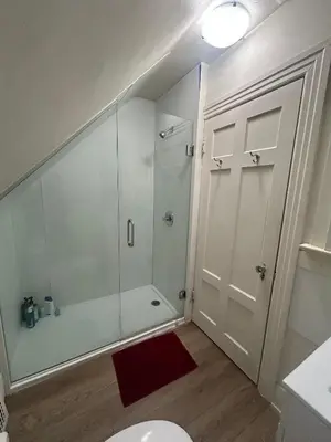a bathroom with a shower with a toilet and a red rug at Vancouver Budget Stay - Airport 10 Min - Free Parking & Fast WiFi in Vancouver