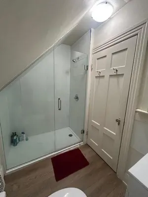 a bathroom with a shower with a glass door at Budget Vancouver Stay - Airport & Downtown 10 & 15 Min, Free Parking & Fast Wifi in Vancouver