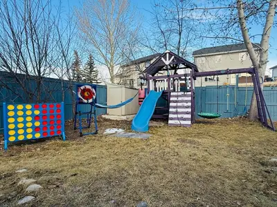a playground with a slide and a play structure at Family-Friendly Home in the Heart of Chestermere in Chestermere