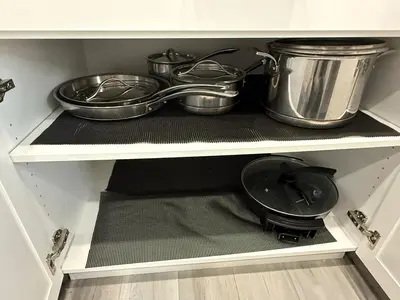 a kitchen with pots and pans on a shelf at Family-Friendly Home in the Heart of Chestermere in Chestermere