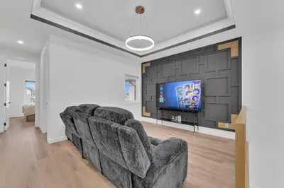 a living room with couches and a flat screen tv at 3 Bedrooms Brand New Luxury Home Close to Amenity in Leduc