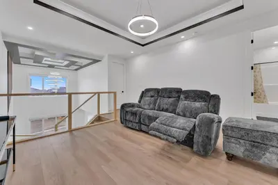 a living room with a couch and a chair at 3 Bedrooms Brand New Luxury Home Close to Amenity in Leduc