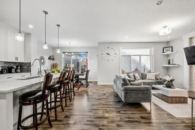 a kitchen and living room with a couch and a table at Spacious 8 Bedroom Family Retreat in Calgary