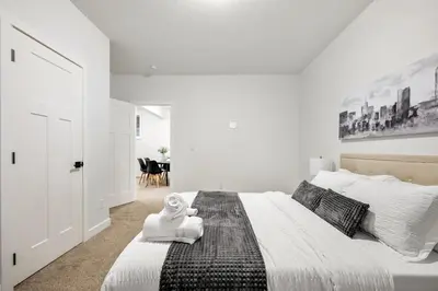 a bedroom with a large bed with a stuffed animal on it at Spacious 8 Bedroom Family Retreat in Calgary