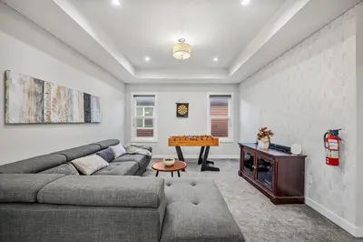 a living room with a couch and a table at Spacious 8 Bedroom Family Retreat in Calgary
