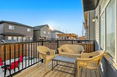 a balcony with two chairs and a bench at Spacious 8 Bedroom Family Retreat in Calgary