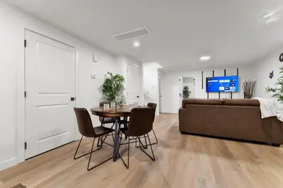 a living room with a table and a couch at 2-bedroom suite close to Amenities and Airport with on pad parking in Leduc