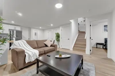 a living room with a couch and a table at 2-bedroom suite close to Amenities and Airport with on pad parking in Leduc