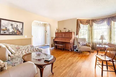 a living room with a couch and a piano at Harmony House short term rental in Okotoks