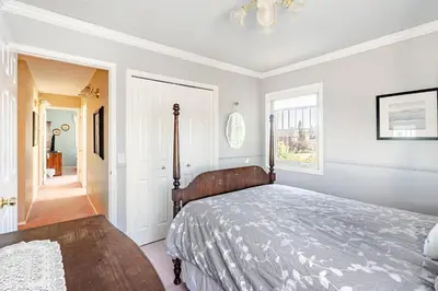 a bedroom with a bed and a chandelier at Harmony House short term rental in Okotoks