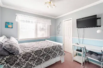 a bedroom with a bed and a desk at Harmony House short term rental in Okotoks
