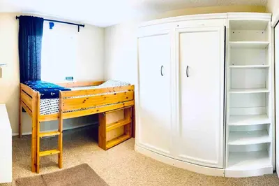 a small room with a desk and a closet at Spacious 3BR Retreat w-Hot Tub Ravine Sleeps 9 in Edmonton
