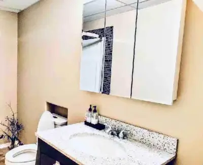 a bathroom with a sink and a mirror and a toilet at Spacious 3BR Retreat w-Hot Tub Ravine Sleeps 9 in Edmonton