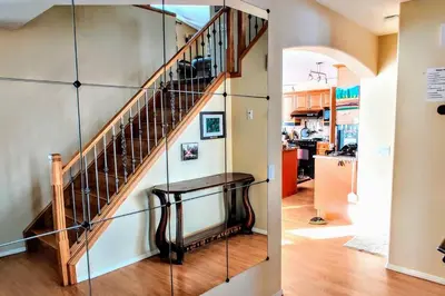 a staircase in a home with a glass wall at Spacious 3BR Retreat w-Hot Tub Ravine Sleeps 9 in Edmonton