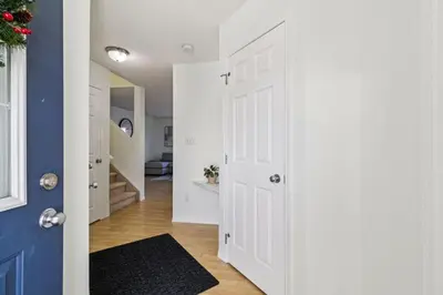 a hallway with a white door and a blue wall at Renovated Cozy Family Home Spacious, Modern in Edmonton