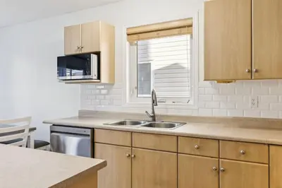 a kitchen with a sink and a window at Renovated Cozy Family Home Spacious, Modern in Edmonton