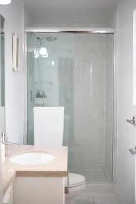 a bathroom with a shower with a toilet and a sink at Private 2BR 2Bath Suite - Sunset Vancouver in Vancouver