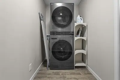 a washer and dryer in a laundry room at Private Guest Suite in SE Calgary 5 minutes to South Health Campus & Seton YMCA in Calgary