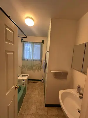 a bathroom with a sink and a tub and a toilet at 3 Private rooms with built-in closet & desk in Edmonton