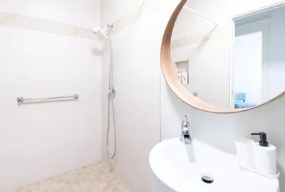 a bathroom with a sink and a mirror at 3Beds Ground-Level Private Suite in Burnaby in Burnaby