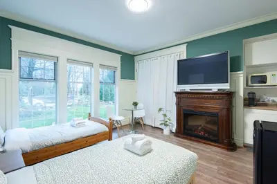 a living room with a fireplace and a flat screen tv at 3Beds Ground-Level Private Suite in Burnaby in Burnaby
