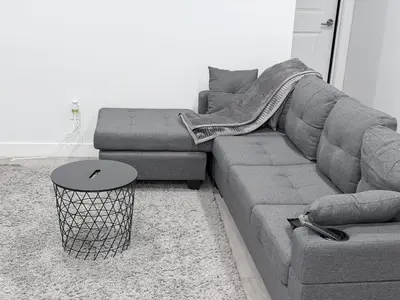 a living room with a couch and a table at The Cozy Spot in Edmonton