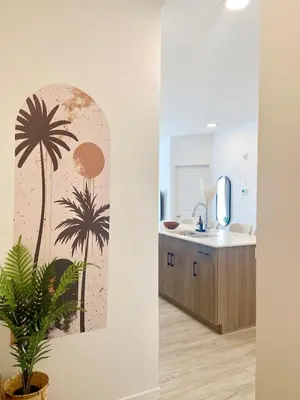 a bathroom with a palm tree mural on the wall at A Touch of the Tropics-Cozy Warm 2BR Stay in Edmonton