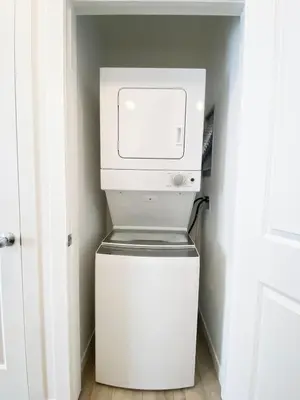 a white washer and dryer in a room at A Touch of the Tropics-Cozy Warm 2BR Stay in Edmonton