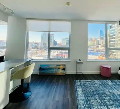 an empty office with a view of a city at Simple Minimalist Condo For Busy Students or Professionals in Calgary