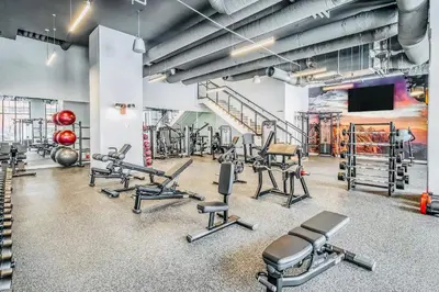 a gym with several treadmills and cardio machines at Simple Minimalist Condo For Busy Students or Professionals in Calgary